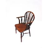 A YEW AND ELM WINDSOR ARMCHAIR with openwork splat back dished seat and crinoline stretcher. 89cms