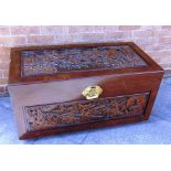 A CAMPHOR WOOD TRUNK with allover carved decoration of sailing boats, 101cm wide 50cm deep 54cm