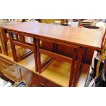 A DANISH TEAK NEST OF THREE TABLES the largest 100cm wide 45cm deep 44cm high, with two smaller