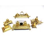 A COLLECTION OF ORNATE BRASS STANDISHES & INKWELLS the largest 27.5cm long, (6).