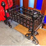 A LARGE WROUGHT IRON FIRE BASKET and pair of andirons, the basket 101cm wide, the andirons 75cm