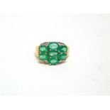 A SEVEN STONE 9 CARAT GOLD EMERALD CLUSTER RING finger, 3.3g gross