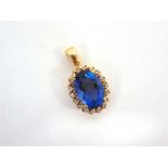 A BLUE TOPAZ AND CUBIC ZIRCONIA 9 CARAT GOLD CLUSTER PENDANT 4g gross