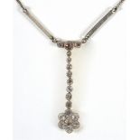 AN EDWARDIAN DIAMOND DROP PENDANT the seven stone flower head cluster to an eight graduated stone