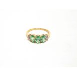 A 9 CARAT GOLD THREE STONE GREEN KYANITE RING with stone set shoulders, finger size O, 1.9g gross