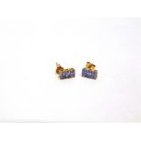 A PAIR OF THREE STONE TANZANITE EARSTUDS stamped '10K', 2g gross