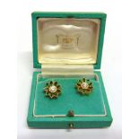 A PAIR OF DIAMOND AND TSAVORITE EARSTUDS unmarked, the central brilliant cut, each of