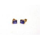 A PAIR OF TANZANITE SINGLE STONE EARSTUDS stamped '10K'