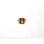A 9 CARAT GOLD CITRINE RING with a diamond to each shoulders finger size N1/2, 3.4g gross