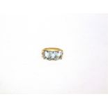 A THREE STONE AQUAMARINE 9 CARAT GOLD RING with stone set shoulders, finger size M, 2.4g gross