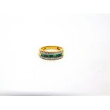 AN EMERALD AND DIAMOND HALF HOOP RING the central line of square cuts with line of thirteen