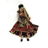 A CLOTH HUNGARIAN MUSICIAN DOLL the felted face and lower arms with painted features, wearing an