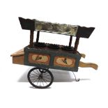 A TOY ICE CREAM VENDOR'S HAND-CART of wooden construction, the canopy with etched glass panels,