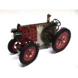 MECCANO - A CONSTRUCTED MODEL TRACTOR with a clockwork motor and steering, 30cm long.