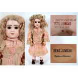 A JUMEAU BISQUE SOCKET HEAD DOLL with a long blonde wig, fixed brown glass paperweight eyes, pierced