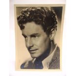 AUTOGRAPHS - AN ALBUM containing hand-signed black and white portrait photographs of Robert Donat,