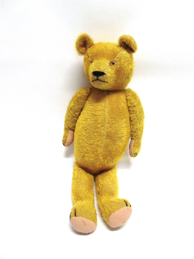 AN ENGLISH YELLOW GOLD MOHAIR TEDDY BEAR with a black horizontally stitched nose (lacking eyes),
