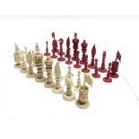A 19TH CENTURY CHINESE CANTON CARVED IVORY CHESS SET natural white and stained red, the kings 10cm