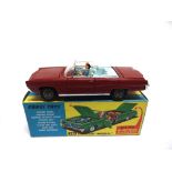 A CORGI NO.246, CHRYSLER IMPERIAL red, with cast hubs, complete with driver and passenger figures,