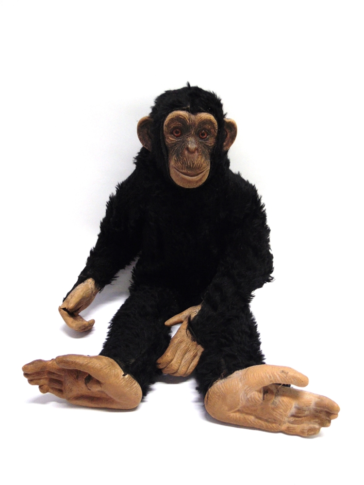 A DEANS RAG BOOK MONKEY SOFT TOY with a rubber composition face, ears, hands and feet, and orange