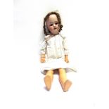 A SIMON & HALBIG BISQUE SOCKET HEAD DOLL with a curled light brown wig, sleeping brown glass eyes,