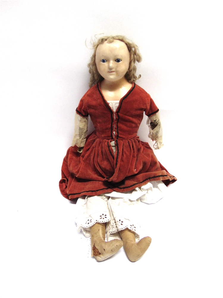A POURED WAX SHOULDER HEAD DOLL with a blonde ringlet wig, inset blue glass eyes and a painted