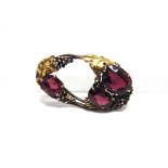 DORRIE ROSSITER, ATTRIBUTED, AN ARTS & CRAFTS BROOCH the oval brooch with oval cut garnets vine