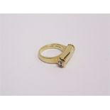 THEO FENNELL, AN 18 CARAT GOLD 'SHAFT' RING London 2003, the cylindrical head running across the