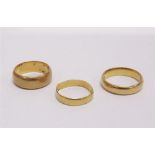 A 22 CARAT GOLD WEDDING RING with two others 15.9g gross