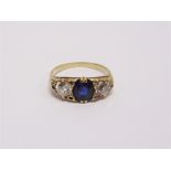 A SAPPHIRE AND DIAMOND THREE STONE RING circa 1910, the oval cut, approximately 7.8mm by 6.5mm by