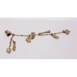 A FANCY LINK BRACELET with seven charms attached, 16.5cm long, 9.8g gross