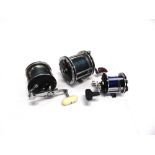 A GROUP OF THREE FISHING REELS including a Penn '65 long beach' with torpedo handle, an an-named