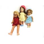 THREE DOLLS comprising a Roddy hard plastic doll with a 'walking' mechanism, 38.5cm high; and two