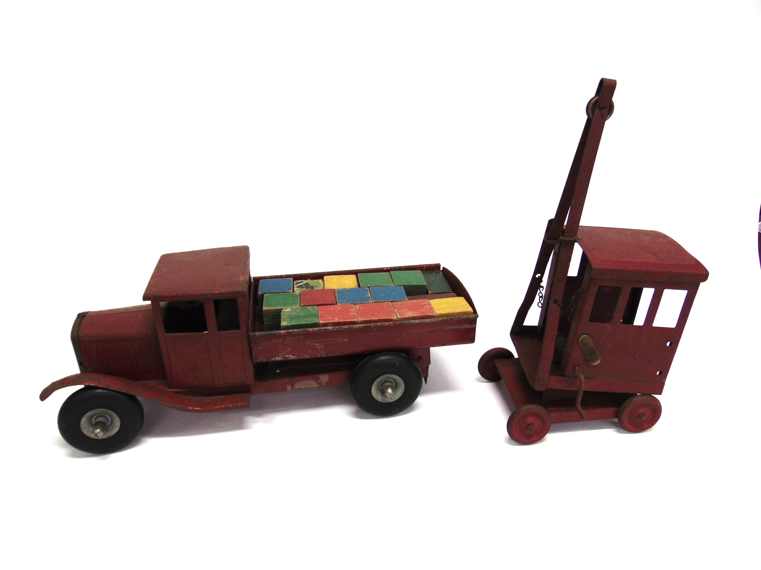 TWO TRI-ANG PRESSED STEEL TOYS comprising a tipper lorry, 48cm long; and a crane, each playworn.