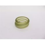 A MONET GREEN PLASTIC BANGLE 3.5cm wide, 6.5cm internal diameter, gilt inlaid tag signed 'Monet'