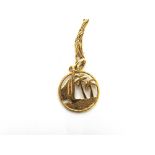 A PENDANT stamped '18c', pierced as a dhow passing pal trees, on a chain stamped '750', 6g gross