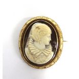 A VICTORIAN SHELL CAMEO BROOCH in an unmarked gold wire decorated mount, carved as an Elizabethan