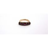 A FIVE STONE RUBY RING unmarked, circa 1900, set with graduated oval and round cuts, finger size