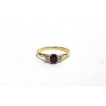 A THREE STONE RUBY AND DIAMOND 18 CARAT RING the brilliant cuts totalling approximately 0.1