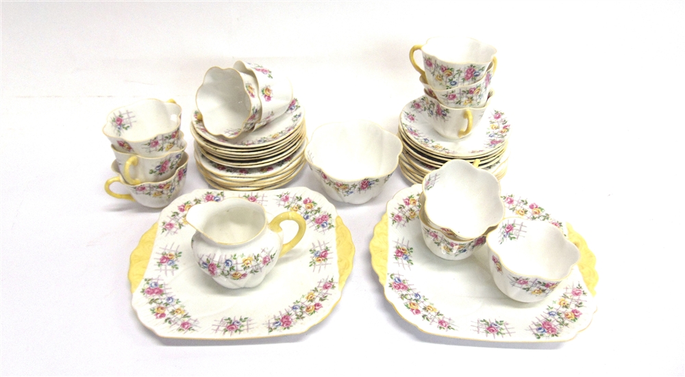 A SHELLEY PART TEA SERVICE decorated with roses on a trellis, comprising pair of sandwich plates,