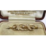 A SEED PEARL SET BROOCH stamped '15ct', 4cm long, 3.9g gross, cased