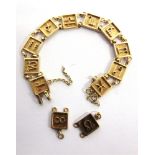 A BRACELET, OF SQUARE LINKS each with a symbol of the zodiac, 22.6g gross, with two spare links, 3.