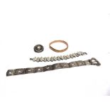 A 9 CARAT GOLD HINGED BANGLE 8.2g gross; a Victorian silver buckle bracelet; another bracelet; and a