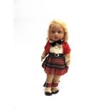 A CLOTH SCOTS GIRL DOLL possibly by Farnell, with a crimped blonde wig and painted facial