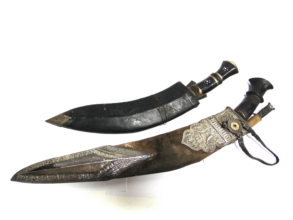 A NEPALESE KUKRI the 42cm typically curved blade with a carved wood grip, in a leather scabbard with