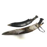 A NEPALESE KUKRI the 42cm typically curved blade with a carved wood grip, in a leather scabbard with