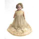 AN ARMAND MARSEILLE BISQUE SOCKET HEAD DOLL with a short blonde wig, fixed blue glass eyes, and an