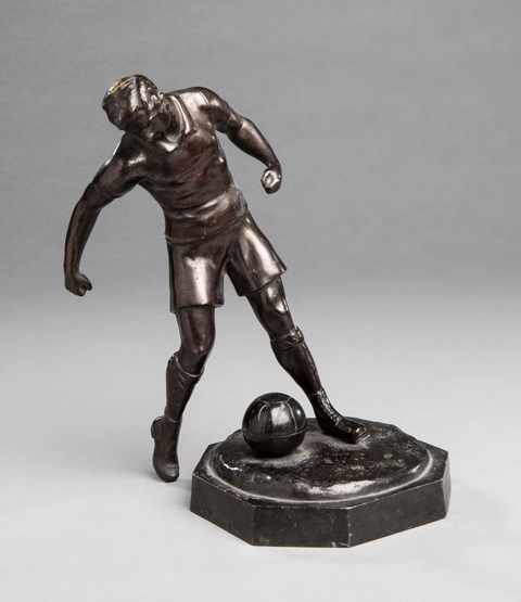 Spelter figure of a footballer, light brown patina,