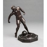 Spelter figure of a footballer, light brown patina,