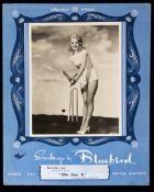 A self-standing shop counter advertisement card for Bluebird Stockings featuring a glamorous film